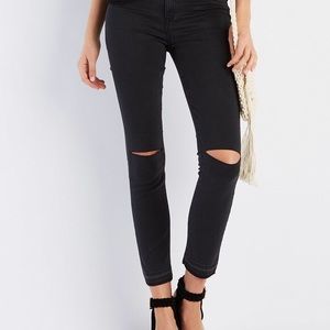 Skinny black jeans with knee slits. Ankle length